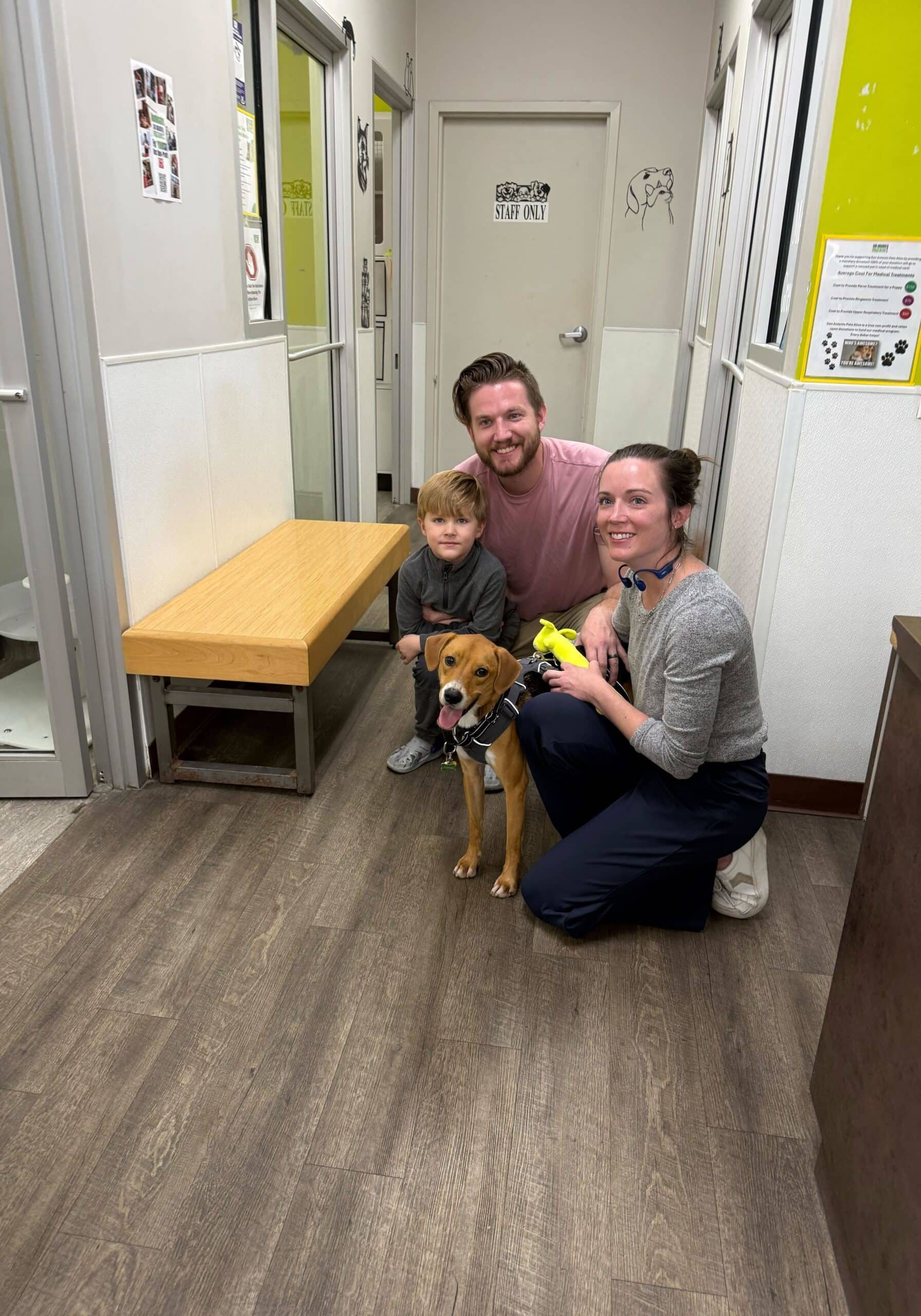 Family with dog at animal shelter